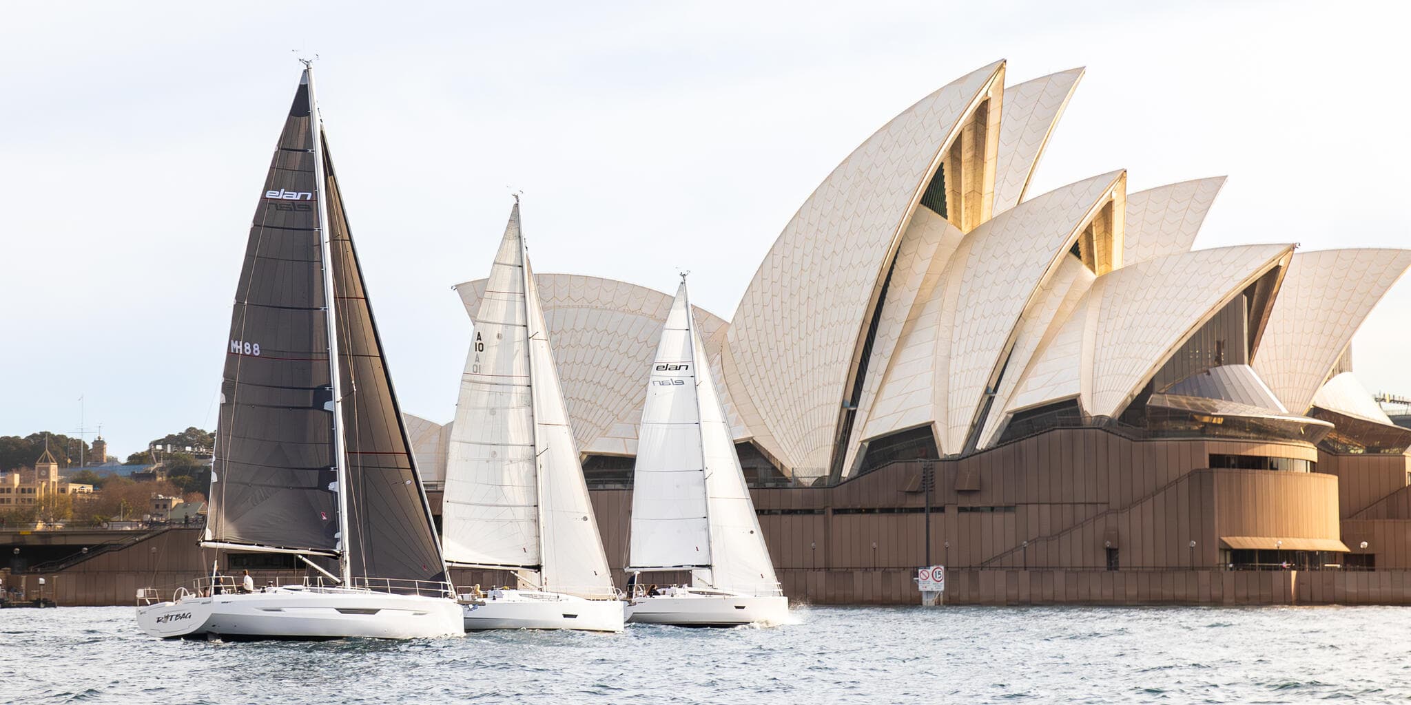 Sailboats racing past Sydney Opera House