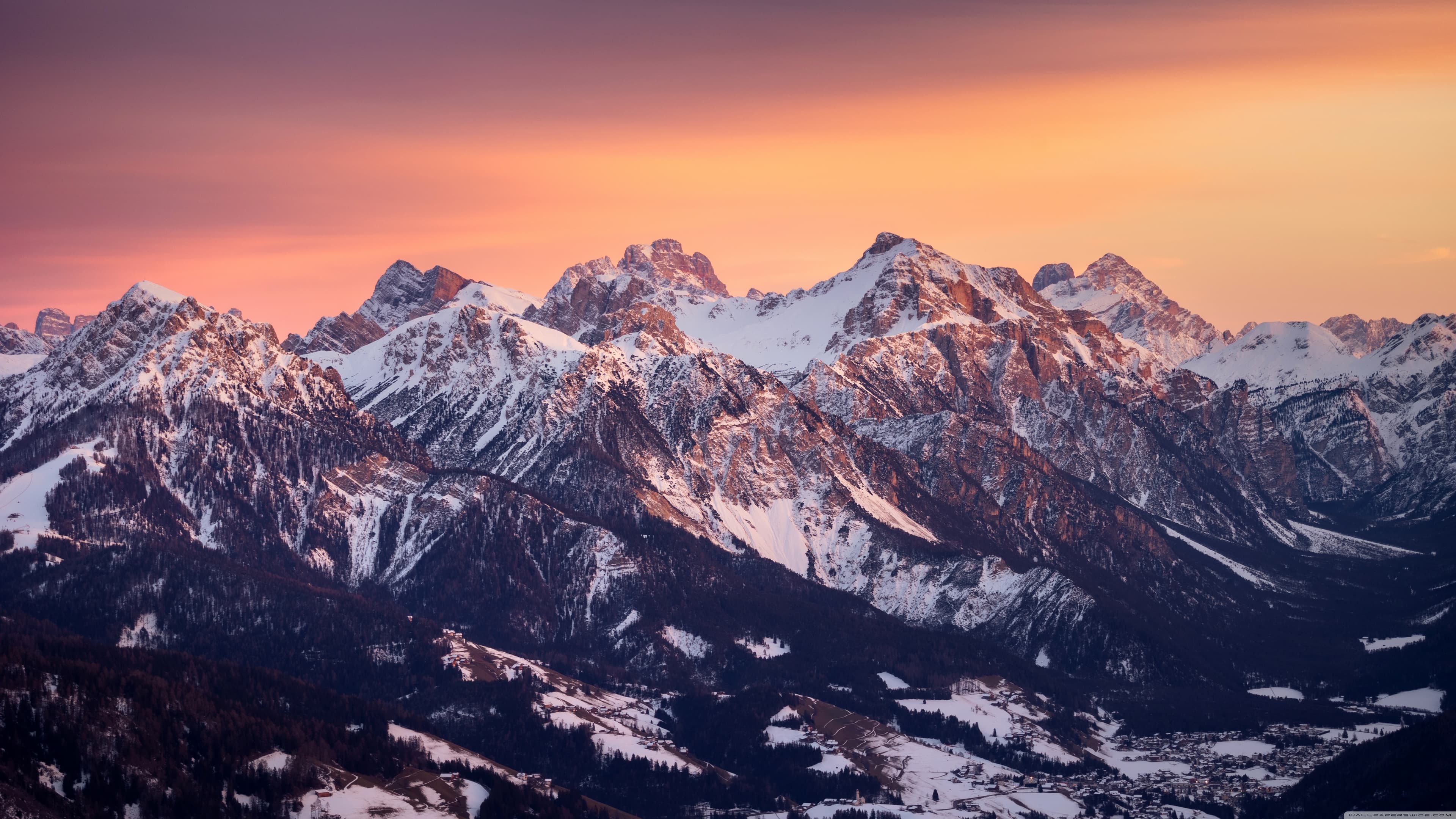 Snow-covered mountain range at sunset